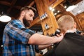 Professional handsome barber holding a hair cutting machine