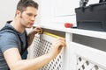 Professional handyman assembling radiator cabinet Royalty Free Stock Photo