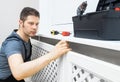 Professional handyman assembling radiator cabinet