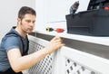 Professional handyman assembling radiator cabinet Royalty Free Stock Photo