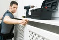 Professional handyman assembling radiator cabinet Royalty Free Stock Photo