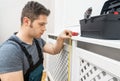 Professional handyman assembling radiator cabinet Royalty Free Stock Photo