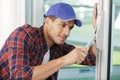 professional handyman fixing window handle at home Royalty Free Stock Photo