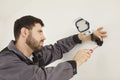 Professional handyman using screwdriver for setting up security camera on white wall Royalty Free Stock Photo