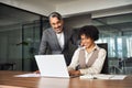 Professional happy manager training helping female employee with computer work. Royalty Free Stock Photo