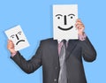 Professional with Happy & Sad face smiles in hands Royalty Free Stock Photo
