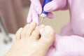 Professional hardware pedicure using an electric machine. Patient at the pedicure procedure. Royalty Free Stock Photo