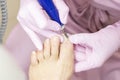 Professional hardware pedicure using an electric machine. Patient at the pedicure procedure. Royalty Free Stock Photo