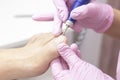 Professional hardware pedicure using an electric machine. Patient at the pedicure procedure. Royalty Free Stock Photo