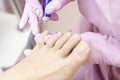 Professional hardware pedicure using an electric machine. Patient at the pedicure procedure. polishing the nail plate