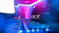 Professional headphones with microphone for video games and cyber sports gaming monitor in neon color blur background