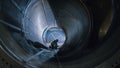 Professional Heavy Industry Welder Working Inside Pipe, Wears Helmet and Starts Welding. Construct Royalty Free Stock Photo