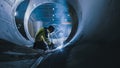 Professional Heavy Industry Welder Working Inside Pipe, Wears Helmet and Starts Welding. Construct Royalty Free Stock Photo