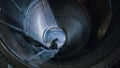 Professional Heavy Industry Welder Working Inside Pipe, Wears Helmet and Starts Welding. Construct Royalty Free Stock Photo