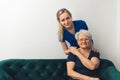 Professional and helpful caregiver comforting senior retired woman at nursing home. Happy retirement and healthcare Royalty Free Stock Photo