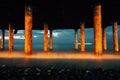 Professional high quality photo. iron columns at the seashore. Photo of waves on a long exposure. Evening photo of the Royalty Free Stock Photo