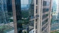 Professional high rise window cleaning service workers in gondola. Two workers use specialized equipment to access and Royalty Free Stock Photo