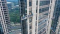 Professional high rise window cleaning service workers in gondola. Two workers use specialized equipment to access and Royalty Free Stock Photo