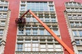 Professional high rise window cleaning service workers on the platform of telescopic boom lift. Two workers use specialized Royalty Free Stock Photo
