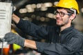 Professional high skill young American new generation worker happy enjoy smiling to work in a heavy industrial factory machine Royalty Free Stock Photo