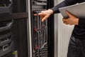 IT Professional Holding Digital Tablet Checking Blade Servers in Datacenter Royalty Free Stock Photo