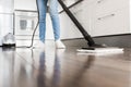 Professional home cleaning service. Woman washes the floor with a steam mop