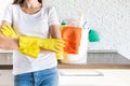 Professional home cleaning. A young woman cleans the apartment. Close-up, rags, sponges and bucket, supplies staff.