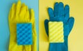Professional house cleaning concept, spring cleaning accessories, two pairs of rubber gloves and sponges on double yellow-blue