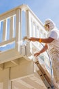 Professional House Painter Wearing Facial Protection Spray Paint