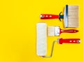Professional house painter, work tools on yellow background Royalty Free Stock Photo