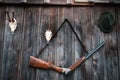 Professional hunters equipment for hunting. Rifle, Deer, Roe deer trophy sculs and others on a wooden black background. Trophy scu Royalty Free Stock Photo