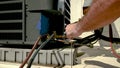 Professional HVAC technician brazing copper to a condenser