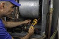 Professional Hvac Technician Checking Current on Motor Wire Royalty Free Stock Photo