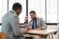 A professional Indian businessman is having a meeting with an African American real estate agent Royalty Free Stock Photo