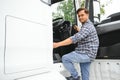 Professional indian truck driver entering his truck long vehicle. Loving his job. Transportation services Royalty Free Stock Photo