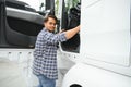 Professional indian truck driver entering his truck long vehicle. Loving his job. Transportation services Royalty Free Stock Photo