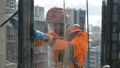 Professional industrial climber washes windows view through glass, background of megalopolis buildings close-up slow Royalty Free Stock Photo