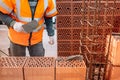 professional industrial construction worker, bricklayer and mason working with bricks