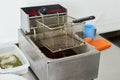 professional restaurant deep fryer with an empty grid for frying Royalty Free Stock Photo