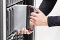 IT professional installs server cluster in large datacenter Royalty Free Stock Photo
