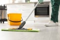 Professional janitor cleaning floor with mop in kitchen, closeup Royalty Free Stock Photo