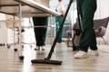 Professional janitor cleaning floor in office