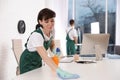 Professional janitor cleaning table in office