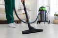 Professional janitor vacuuming floor in living room, closeup Royalty Free Stock Photo