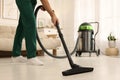 Professional janitor vacuuming floor in living room, closeup Royalty Free Stock Photo