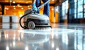 Professional janitorial staff using an industrial floor buffer machine for cleaning and polishing the hallway of a modern