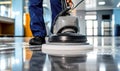 Professional janitorial staff using an industrial floor buffer machine for cleaning and polishing the hallway of a modern