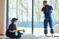 Professional janitors in blue uniform cleaning bathroom Royalty Free Stock Photo