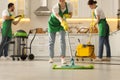 Professional janitors working in kitchen, closeup. Cleaning service Royalty Free Stock Photo