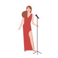 Professional jazz singer, vocalist or songstress wearing elegant red evening dress and holding microphone stand. Female